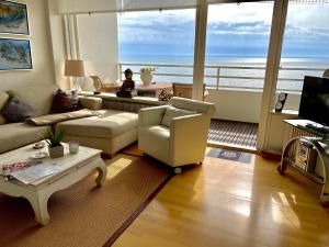 a living room with a view of the ocean at Apartment am Meer in Sierksdorf