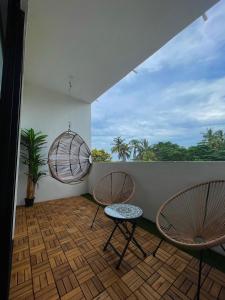 two chairs and a table on a balcony at océano estudio 2 in Sayulita