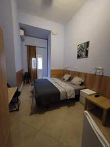 a bedroom with a bed and a table in it at Mini-hotel Casa de la Luz in Alicante