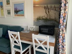 a living room with a table and chairs and a couch at Chalet 283 in Bridlington