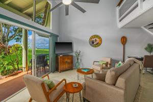 a living room with a couch and chairs and a tv at Beautiful 2Br 2Ba Puamana, Ocean and Mountain View, Pool in Princeville