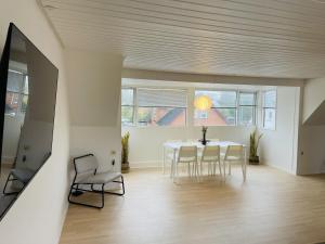 a dining room with a table and chairs at aday - Modern 3 bedrooms apartment in Svenstrup in Svenstrup