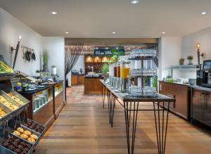 a bakery with a counter with food on it at Delta Hotels by Marriott Worsley Park Country Club in Worsley