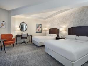 a hotel room with two beds and a desk at Delta Hotels by Marriott Worsley Park Country Club in Worsley +113 photos