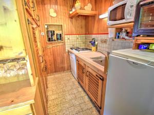 a small kitchen with a stove and a refrigerator at Chalet Morzine, 4 pièces, 10 personnes - FR-1-524-6 in Morzine