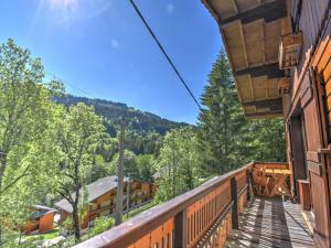 a balcony of a house with a view of the forest at Chalet Morzine, 4 pièces, 10 personnes - FR-1-524-6 in Morzine