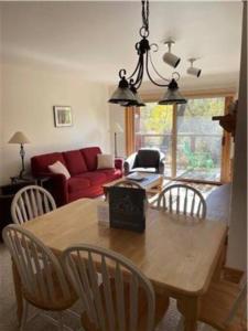 a living room with a wooden table and chairs at Condo, Driggs - Bannock 216 in Driggs