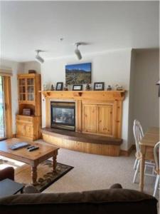 a living room with a fireplace and a table at Condo, Driggs - Bannock 216 in Driggs