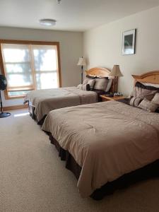 a hotel room with two beds and a window at Condo, Driggs - Bannock 216 in Driggs