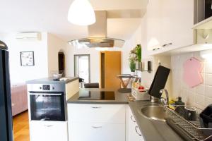 a kitchen with white cabinets and a sink at Anchie in Zagreb