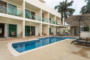 a swimming pool in front of a building at PETRAS HOTEL in Brisas de Zicatela