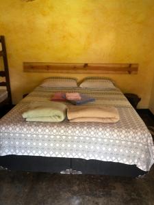 Tempat tidur dalam kamar di Fazendinha da Canastra