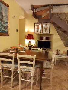 a dining room with a wooden table and chairs at Linda's Holiday Home in Roccastrada