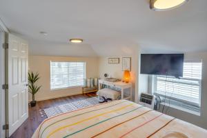 a bedroom with a bed and a desk and a tv at Downtown Home with Free Parking, Less Than 1 Mi to Beach! in Long Beach