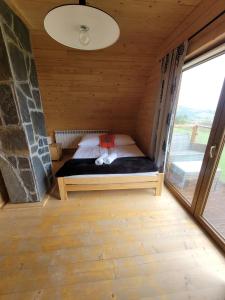 a small bed in a room with a window at Osada pod Giewontem 3 - KACPROWY in Czerwienne