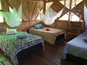 Postel nebo postele na pokoji v ubytování Ecohotel Soplo del Tambo