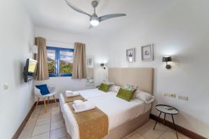 a bedroom with a large bed and a window at Jasmin in Puerto Calero +18 photos