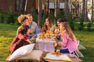 a group of people sitting around a picnic table at Harmony Green Village Resort in Mahmudiye