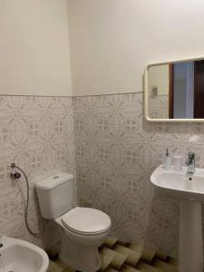 a bathroom with a toilet and a sink at Caminho da Vila moradia. in Escalos de Cima +9 photos