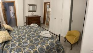 a bedroom with a bed and a chair and a mirror at Trebiano a casa dei nonni in Arcola