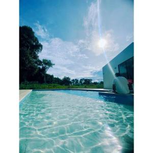 a swimming pool with water in front of a building at Casa Campestre Ensueño in Ricaurte