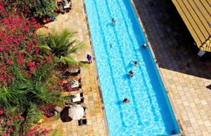 an overhead view of a swimming pool with people in it at Lacqua diroma Caldas Novas - Piscinas 24 horas - Apartamento com Cozinha Americana in Caldas Novas