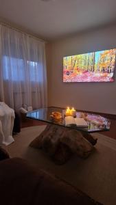 a living room with a glass table with candles on it at Las Golondrinas de Henche 