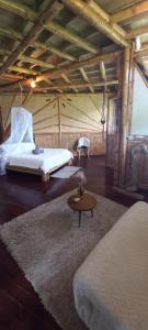 Postel nebo postele na pokoji v ubytování Ecohotel Soplo del Tambo