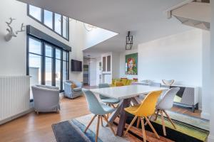 een eetkamer en een woonkamer met een tafel en stoelen bij PENTHOUSE Luxe DISNEYLAND PARIS in Chessy