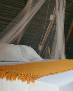 a close up of a bed with curtains on it at La Chantin in Pedregal