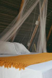 a bed with a canopy and curtains on it at La Chantin in Pedregal