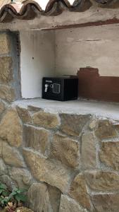a microwave sitting on top of a stone wall at Alloggio Turistico Casa di Luca e Vale in Campotosto