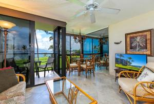 a living room with a view of the ocean at Kihei Surfside 307 - MCH in Kihei