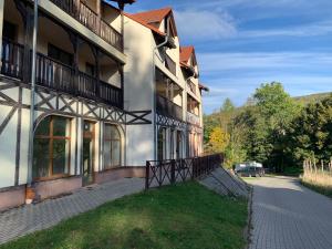 a building with a gate in front of it at Apartament Kalina - Wyszyńskiego in Świeradów-Zdrój