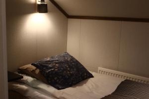 a bedroom with a bed with a pillow on it at Motelli Nuttulinna in Nuttupera