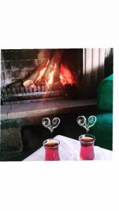 two cups on a table in front of a fireplace at TATİL KEYFİ MOTEL in Kocaeli