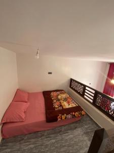 a small room with a red bed in the corner at Ayour Beach House 1 in Imsouane