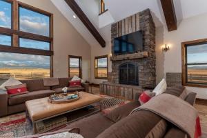 a living room with a couch and a fireplace at Postcard Views, Teton Valley Id in Tetonia