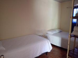 a bedroom with two beds and a bunk bed at Villas El Alto 3 in Tambor