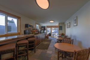 a kitchen with wooden tables and chairs and a counter at Antler Inn in Jackson