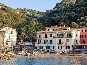 a group of buildings on the shore of a body of water at Brezza Marina in Massa Lubrense