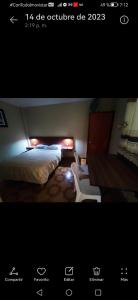 a picture of a room with two beds with lights at Hostal Continental in Nazca