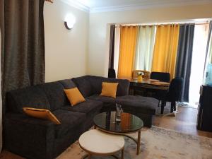 CeeJ'S Airbnb في Meru: غرفة معيشة مع أريكة وطاولة