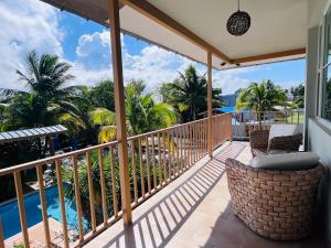 a balcony with chairs and a view of the ocean at Numero Uno Piñones in Loiza