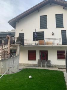 a house with a yard with a soccer ball on the lawn at B&B Kalbermatter in Turtmann