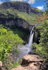 a waterfall on the side of a mountain at Villa de Assis Suítes in Alto Paraíso de Goiás