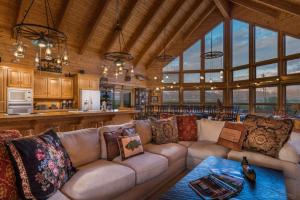 a living room with a couch and a kitchen at Teton Riverfront Property in Victor