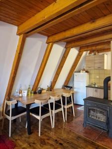 a kitchen with a wooden table and a stove at Green Eye in Žabljak