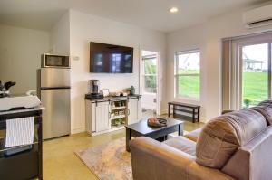 a living room with a couch and a refrigerator at Chic and Modern Snohomish Hideaway on a Working Farm in Snohomish