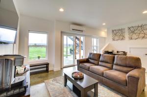 a living room with a couch and a table at Chic and Modern Snohomish Hideaway on a Working Farm in Snohomish
